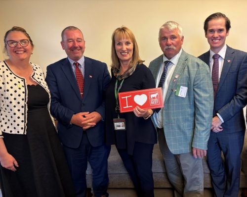 five people holding I love Beef sign
